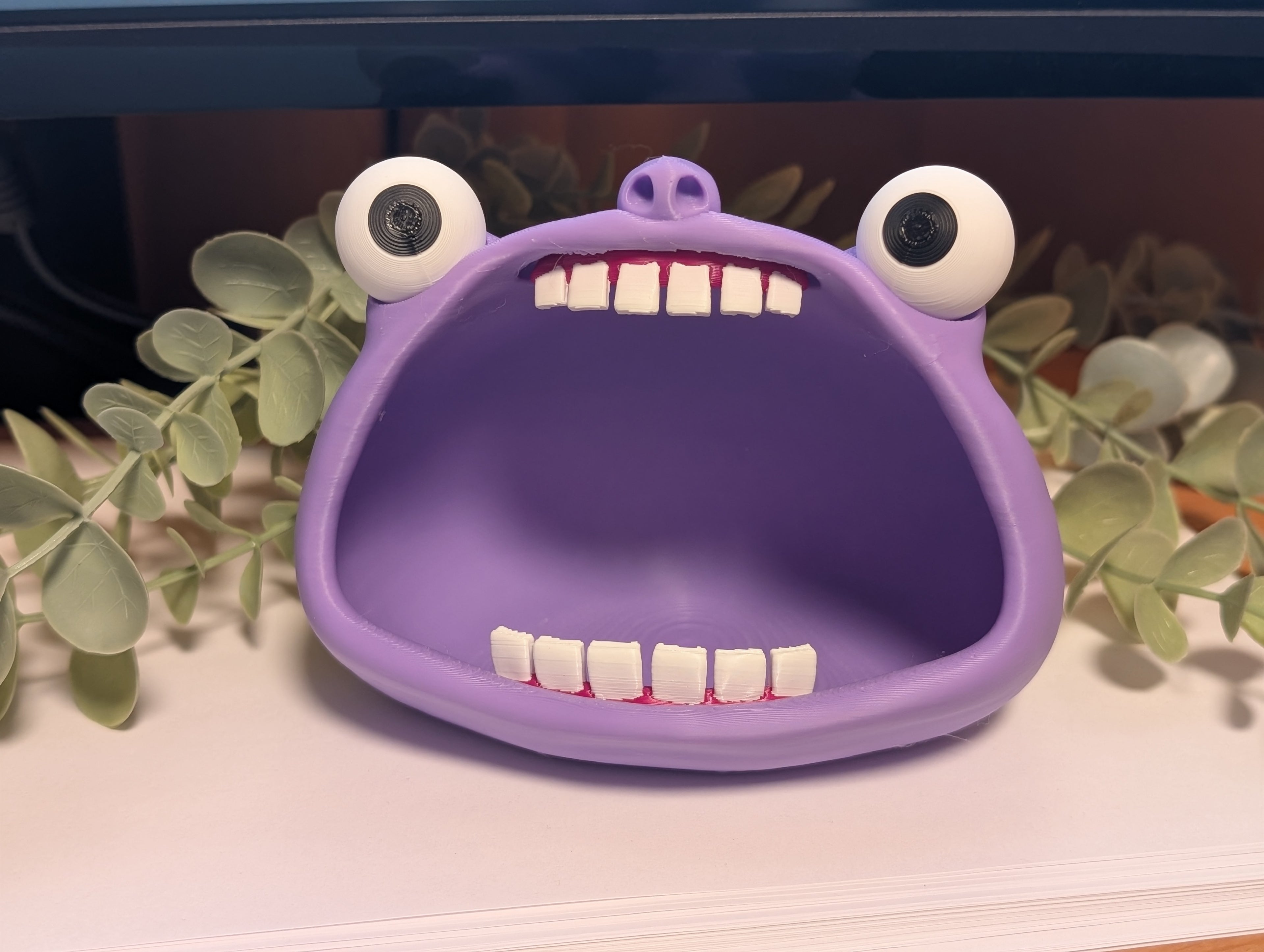 Purple trinket bowl shaped like a monster's head with googly eyes and a wide mouth.